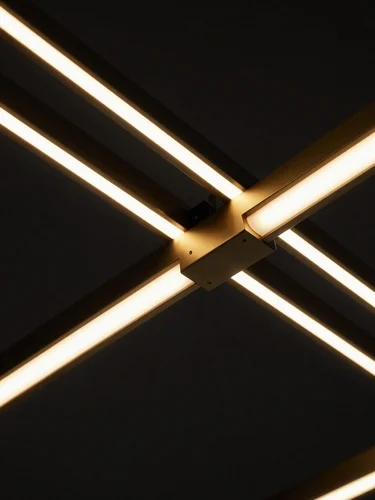 Close-up macro detail of modern minimalist gold and matte black LED fixture engineering, technical lines on dark background