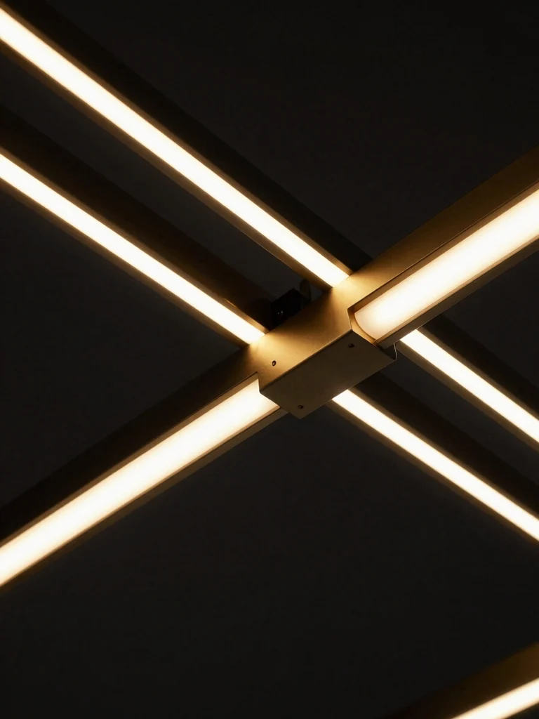 Close-up macro detail of modern minimalist gold and matte black LED fixture engineering, technical lines on dark background